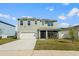 Charming two-story home featuring a spacious two-car garage and a welcoming screened-in porch at 2736 Dumont Ln, Tavares, FL 32778