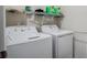 Bright laundry room with new washer and dryer set, plus overhead storage shelf at 2736 Dumont Ln, Tavares, FL 32778