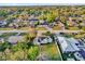 Aerial view of a neighborhood showcasing homes with solar panels and lush greenery at 295 Garland St, Deltona, FL 32725