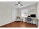 Bright bedroom with dark wood floors features a ceiling fan and a work area near the window at 295 Garland St, Deltona, FL 32725