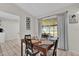 Cozy dining area with a view of the screened-in patio and backyard at 295 Garland St, Deltona, FL 32725