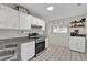 Functional kitchen featuring white cabinets, stainless steel appliances, and granite countertops at 295 Garland St, Deltona, FL 32725