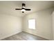 Well-lit bedroom with ceiling fan, light gray floors and window at 300 S Aurora Dr, Apopka, FL 32703