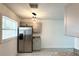 Bright kitchen featuring stainless steel refrigerator and a modern light fixture, offering a blend of style and functionality at 300 S Aurora Dr, Apopka, FL 32703