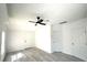 Bright living room with light gray flooring, ceiling fan and white painted doors at 300 S Aurora Dr, Apopka, FL 32703