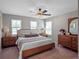 Charming primary bedroom with a ceiling fan and three bright windows at 31807 Broadwater Ave, Leesburg, FL 34748