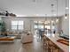 Bright and airy living room featuring an open-concept design, tile floors, and sliding doors to outdoor space at 31807 Broadwater Ave, Leesburg, FL 34748