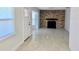 Open living room with brick fireplace, lots of natural light, neutral colors, and tile floors at 32803 Forest Ave, Leesburg, FL 34788