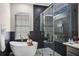 Modern bathroom featuring a freestanding tub, glass shower, and sleek fixtures with natural light at 334 Prestwick Dr, Davenport, FL 33897