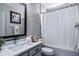 Bathroom featuring a vanity with quartz countertop, decorative mirror, and shower-tub combination at 334 Prestwick Dr, Davenport, FL 33897