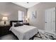 Cozy bedroom with a queen-sized bed, neutral tones, and stylish bedside lamps on dark wood nightstands at 334 Prestwick Dr, Davenport, FL 33897