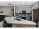 Modern kitchen featuring gray cabinets, stainless steel appliances, and a large quartz countertop island at 334 Prestwick Dr, Davenport, FL 33897