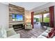 Living room with a modern fireplace, wall-mounted TV, and access to a screened patio at 334 Prestwick Dr, Davenport, FL 33897