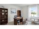 Bright home office featuring a desk, bookshelves, and a window with natural light and two chairs at 3897 Diving Dove Ln, Bartow, FL 33830