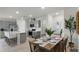 Modern kitchen and dining area with stainless steel appliances and a center island with barstool seating at 3913 Diving Dove Ln, Bartow, FL 33830