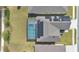 Aerial top-down view of home, featuring solar panels and screened-in pool at 520 Pinecrest Loop, Davenport, FL 33837