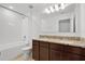 Bathroom featuring double sink vanity with granite countertop, a bathtub, and tiled floors at 520 Pinecrest Loop, Davenport, FL 33837