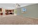 Open living space adjacent to the kitchen, featuring carpet, tile flooring, and sliding glass doors at 520 Pinecrest Loop, Davenport, FL 33837