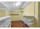 Organized closet with wooden floors, white shelving, and wire basket storage at 7468 Swallow Run # 38, Winter Park, FL 32792