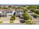 Aerial view of a two-story home with lush landscaping, brick driveway, and mature shade trees at 7641 Fairfax Dr, Kissimmee, FL 34747