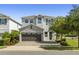 Charming two-story home featuring a stone facade, a two car garage, and a well-maintained front yard at 7641 Fairfax Dr, Kissimmee, FL 34747