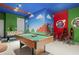 Entertaining game room with a pool table, foosball table, tv, and Mario themed decorations at 7641 Fairfax Dr, Kissimmee, FL 34747