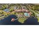 Aerial shot showcases community amenities: pool, clubhouse, tennis courts, lake with dock at 846 Asturias Rd, Davenport, FL 33837