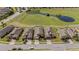 Aerial view of homes backing to green space and pond with street and parked cars visible at 846 Asturias Rd, Davenport, FL 33837