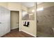 Modern bathroom featuring a tiled shower with a glass enclosure and hardwood floors at 846 Asturias Rd, Davenport, FL 33837