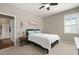 Bedroom features a neutral color scheme, window with plantation shutters, and an ensuite bathroom at 846 Asturias Rd, Davenport, FL 33837