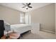 Bright bedroom features a ceiling fan, white closet doors, and a dresser with carpet flooring at 846 Asturias Rd, Davenport, FL 33837