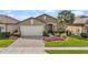 Charming single-story home with brick paved driveway and meticulously manicured landscaping at 846 Asturias Rd, Davenport, FL 33837