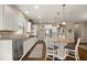 Well-lit kitchen with white cabinets, granite countertops, stainless steel appliances, and hardwood floors at 846 Asturias Rd, Davenport, FL 33837