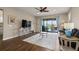 Cozy living room with hardwood floors and sliding glass doors to the outdoor patio at 846 Asturias Rd, Davenport, FL 33837