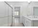 Bathroom featuring a dual vanity sink, a glass door walk-in shower, and neutral tones at 8651 Sw 138Th St # 68, Ocala, FL 34473