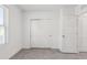 Well-lit bedroom with neutral tones, tile flooring, closet doors and natural light from the window at 8651 Sw 138Th St # 68, Ocala, FL 34473