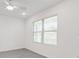 Bright bedroom featuring tile flooring, a ceiling fan, and a large window at 8651 Sw 138Th St # 68, Ocala, FL 34473