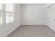A cozy bedroom features neutral tones, window with blinds, and tile flooring at 8651 Sw 138Th St # 68, Ocala, FL 34473