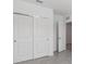 A bedroom featuring large sliding door closet, neutral walls and gray tile flooring at 8651 Sw 138Th St # 68, Ocala, FL 34473