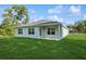 Back of home, featuring a pristine lawn and a bright sky at 8651 Sw 138Th St # 68, Ocala, FL 34473