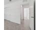 Hallway showcases tile flooring, doorways leading to other rooms, and neutral paint at 8651 Sw 138Th St # 68, Ocala, FL 34473