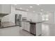Open kitchen with stainless steel appliances, white cabinets and kitchen island at 8651 Sw 138Th St # 68, Ocala, FL 34473