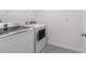 A clean laundry room features a washer and dryer with minimalist design at 8651 Sw 138Th St # 68, Ocala, FL 34473