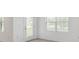 A brightly lit room with a door leading outside and a window with blinds offers neutral tones at 8651 Sw 138Th St # 68, Ocala, FL 34473