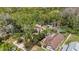 An aerial view of the home with a large backyard, shed, and above ground pool, surrounded by trees at 9939 Triple Crown Cir, Orlando, FL 32825