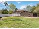 Backyard featuring garden beds, white vinyl fence and expansive green lawn; perfect for gardening enthusiasts at 9939 Triple Crown Cir, Orlando, FL 32825