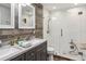 Modern bathroom featuring double sinks, a walk-in shower, and stylish wood and subway tile at 9939 Triple Crown Cir, Orlando, FL 32825