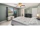 Tranquil bedroom with a ceiling fan, tv, and view to ensuite bathroom at 9939 Triple Crown Cir, Orlando, FL 32825