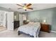 Cozy bedroom with a ceiling fan, and view to ensuite at 9939 Triple Crown Cir, Orlando, FL 32825