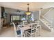 Dining area with wood plank ceiling, brick fireplace and stairway at 9939 Triple Crown Cir, Orlando, FL 32825